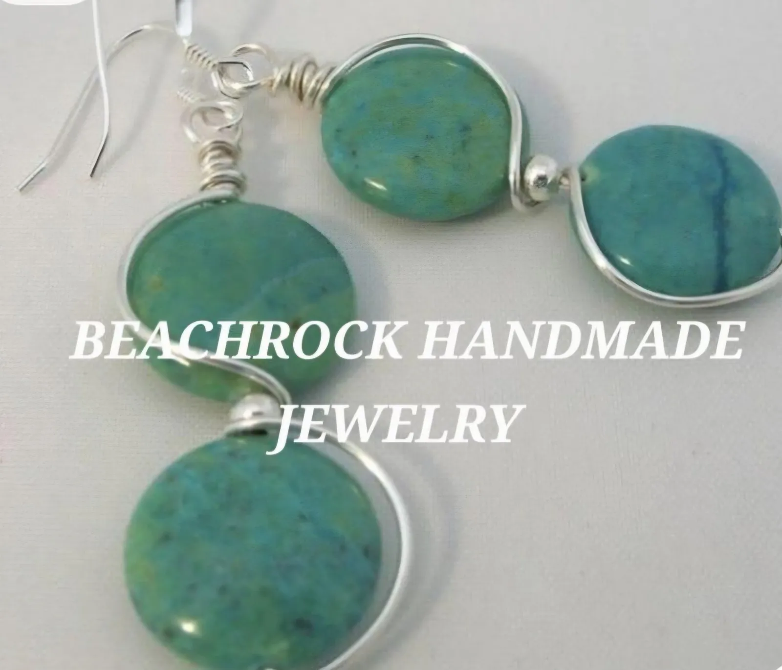 Silver wire earrings, each holding two round turquoise-green stone beads, with the words Beachrock Handmade Jewelry across the photo