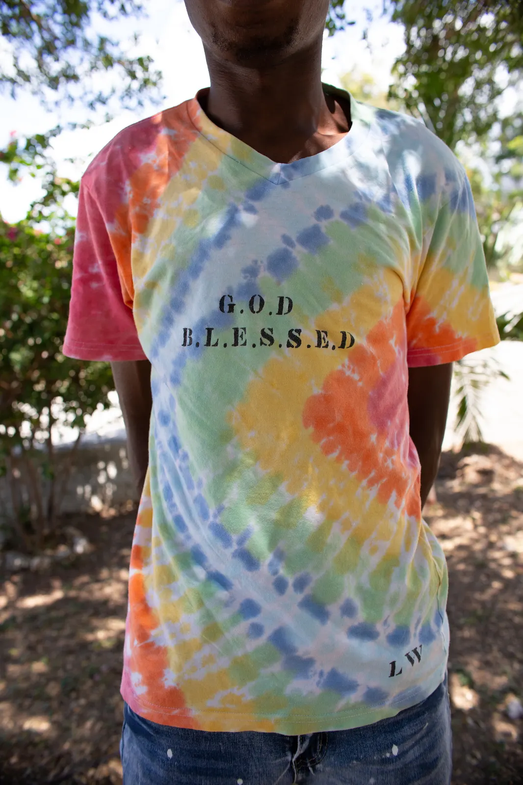 A tie-dye T-shirt stencilled “G.O.D B.L.E.S.S.E.D” and signed LW