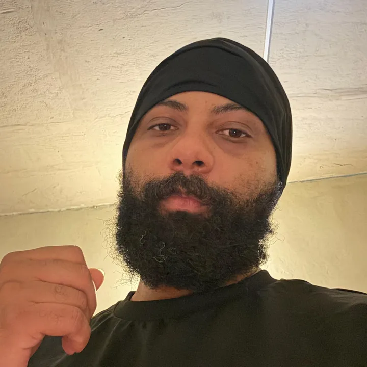 Sheldon Hill, in a black head wrap and T-shirt