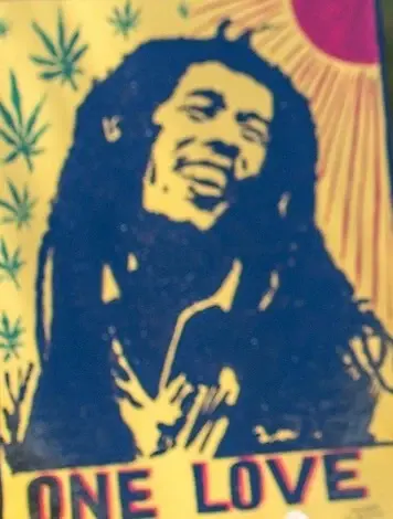 A “One Love” print of Bob Marley on yellow