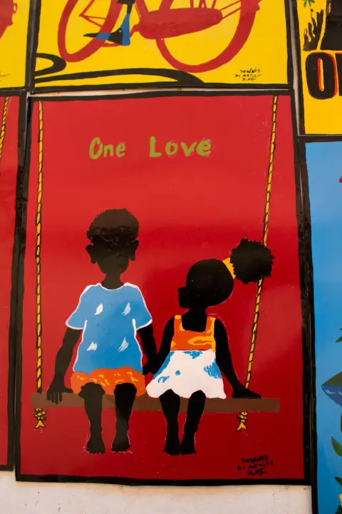 “One Love”: two children holding hands on a swing, signed Dennis Di Artist