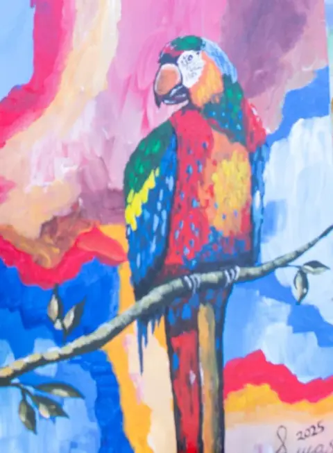 A painting of a red and blue parrot on a branch