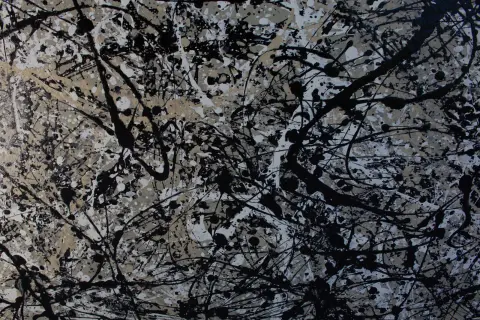 A drip painting in black, white and grey