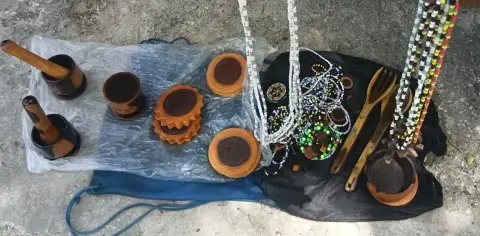 Carved wooden mortars and pestles, coasters, bowls and spoons, with beaded necklaces