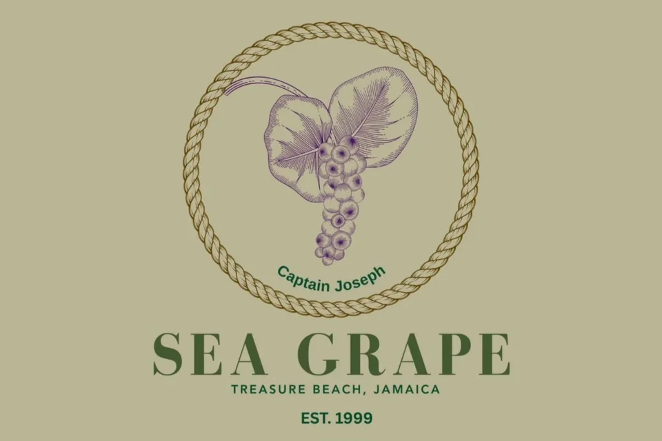 The Sea Grape logo on a sage-green ground: a sea grape leaf and a bunch of grapes in purple line art, inside a gold rope ring marked Captain Joseph, above the words SEA GRAPE, Treasure Beach, Jamaica, est. 1999