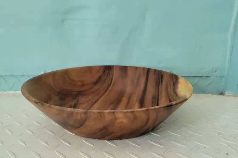 A turned wooden bowl with dark swirling grain