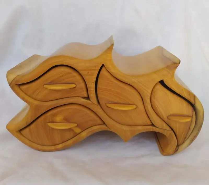 A yellow wooden jewellery box in leaf shapes, with five drawers