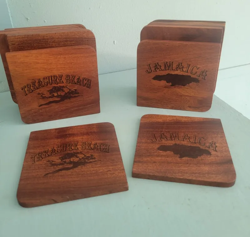 Wooden coasters engraved Treasure Beach, with a tree, and Jamaica, with a map of the island