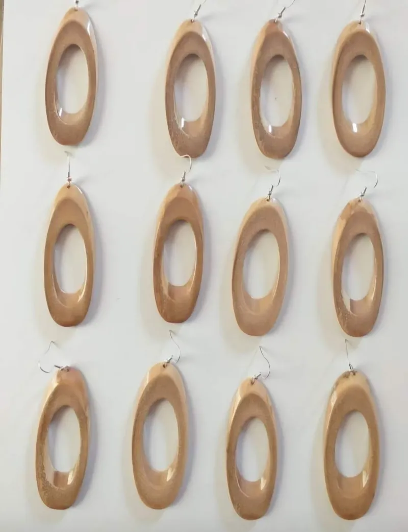 Twelve long oval wooden earrings with cut-out centres